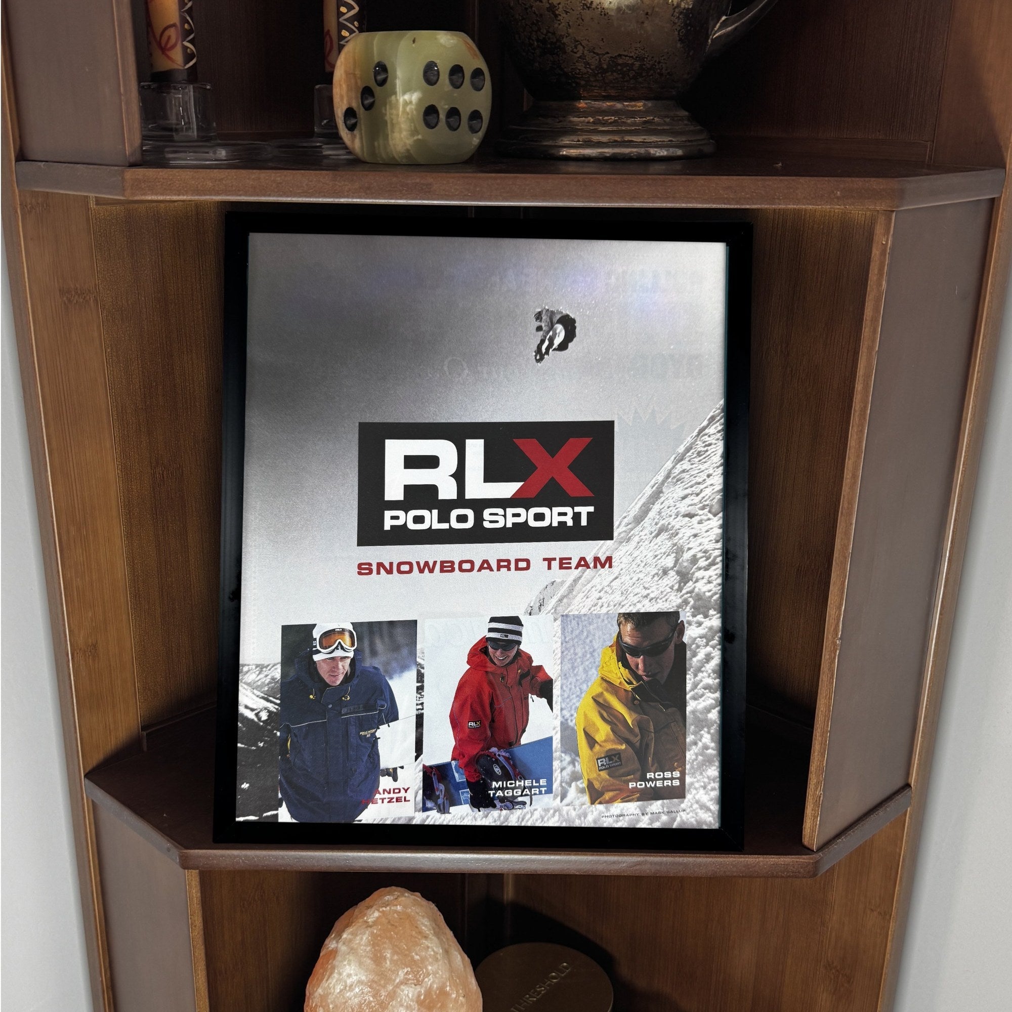 RLX Polo Sport framed print displayed on a wooden shelf