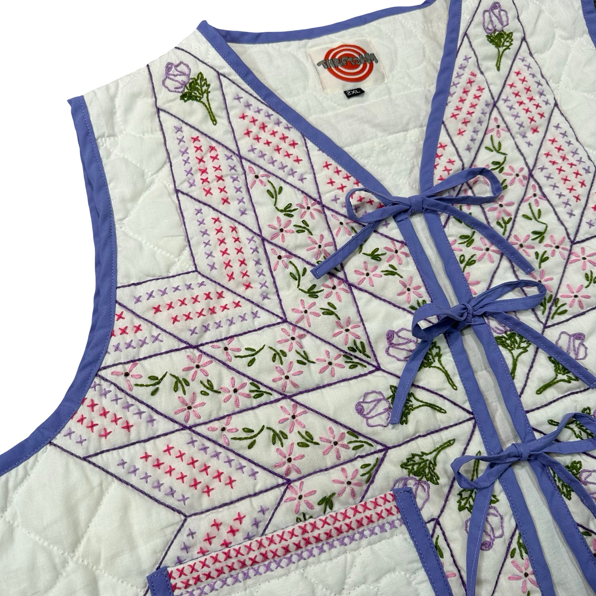 Periwinkle Cross Stitch Star quilted vest rework, front tie closures detail