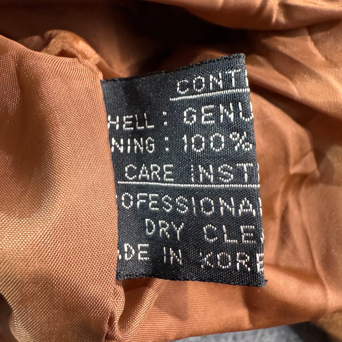 Care and content tag inside tan suede jacket
