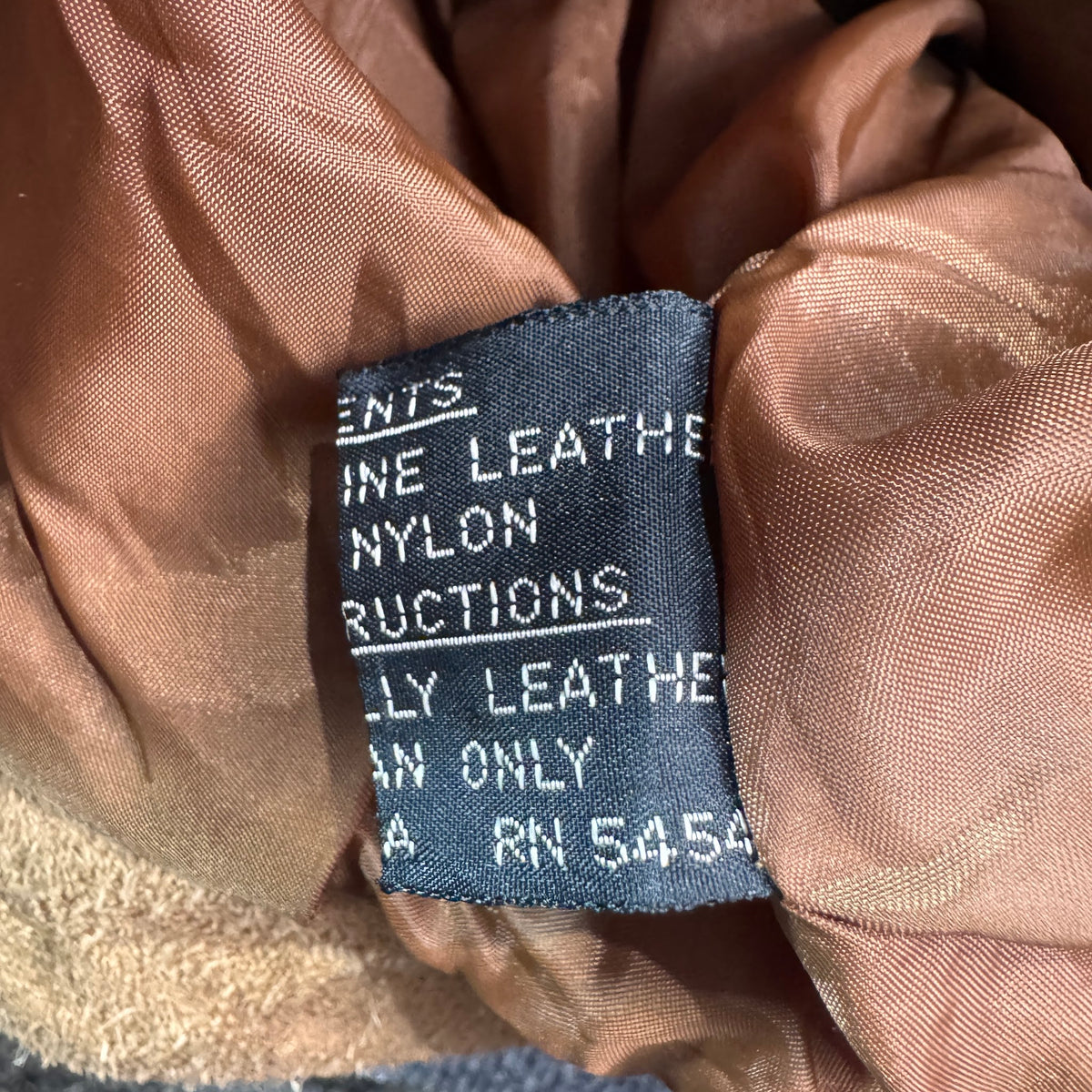 Content tag showing genuine leather shell and nylon lining