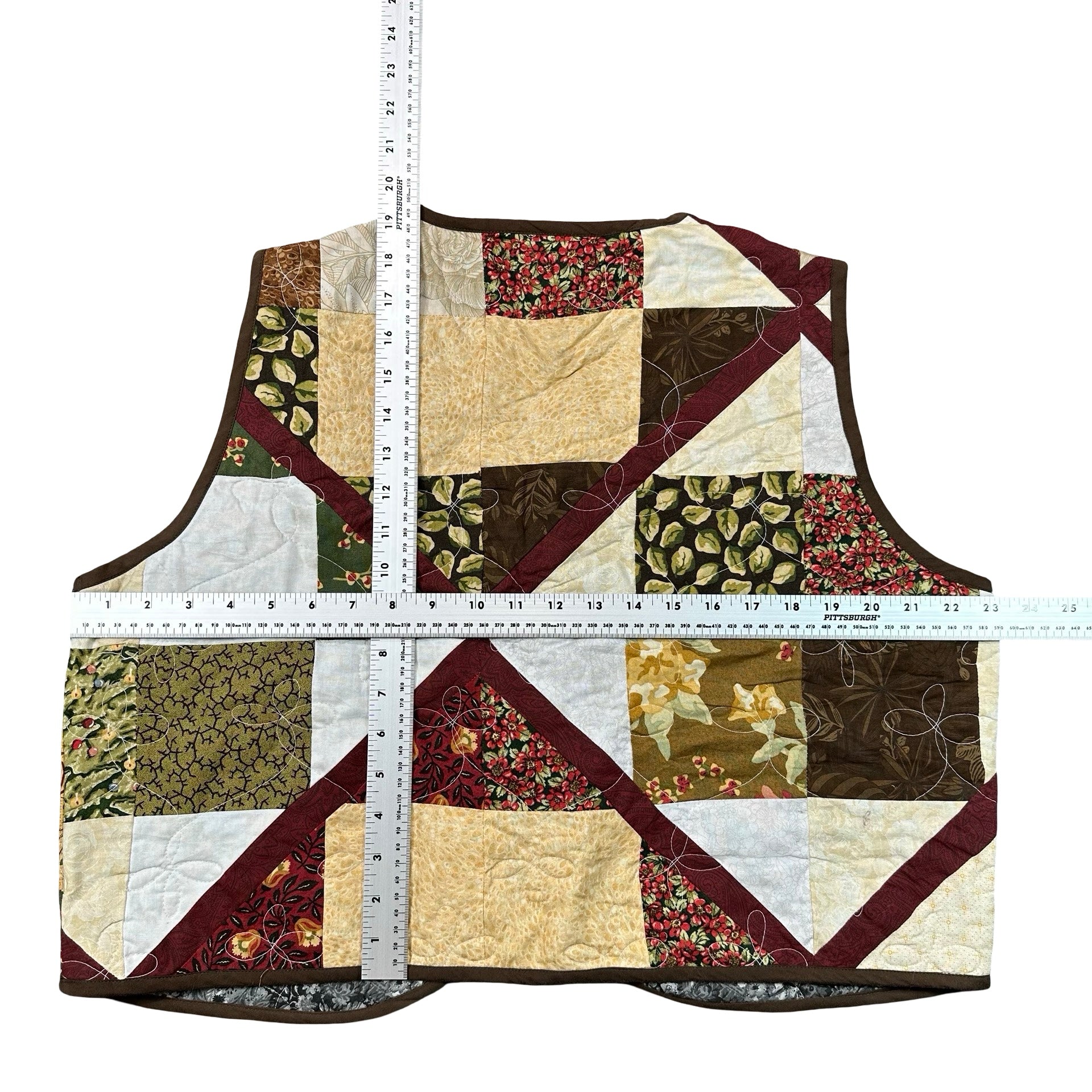 Autumn Earth Patchwork XL quilted vest rework, tape measure across the chest
