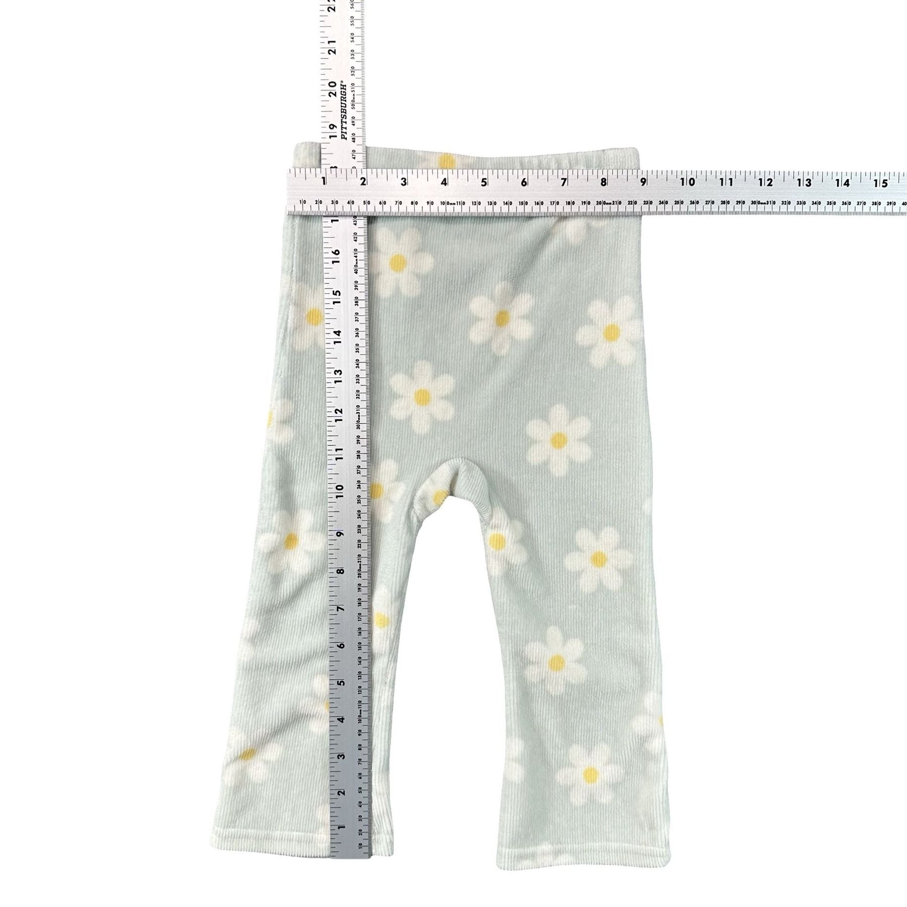Sage Green Daisy Print Baby Leggings 18M - flat lay measurements with tape measure
