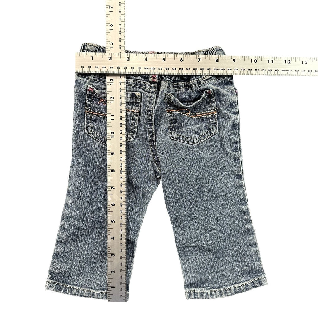 Xhilaration Embroidered Baby Jeans 12M - flat lay measurements with tape measure