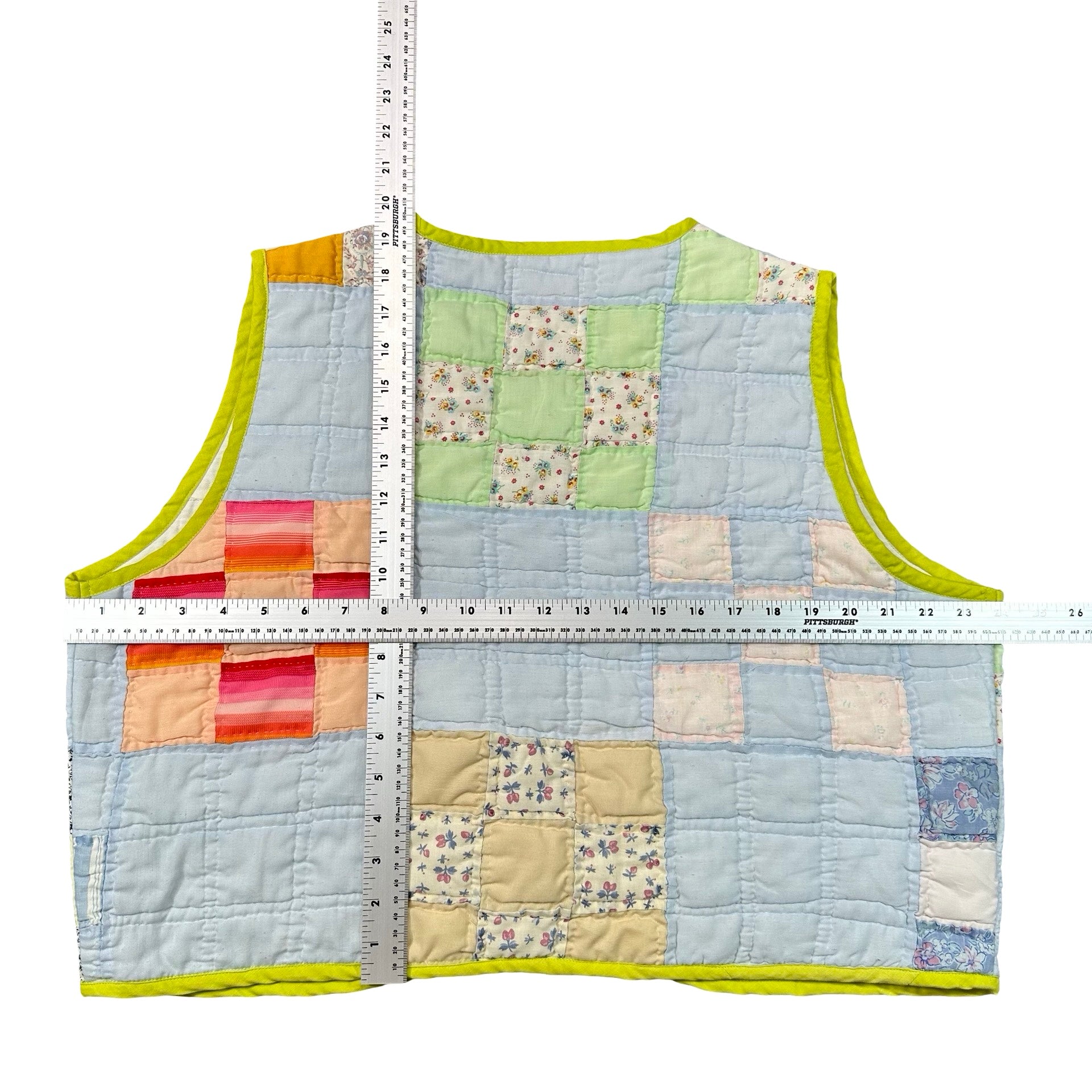 Powder Blue & Lime Patchwork XL quilted vest rework, tape measure across the chest