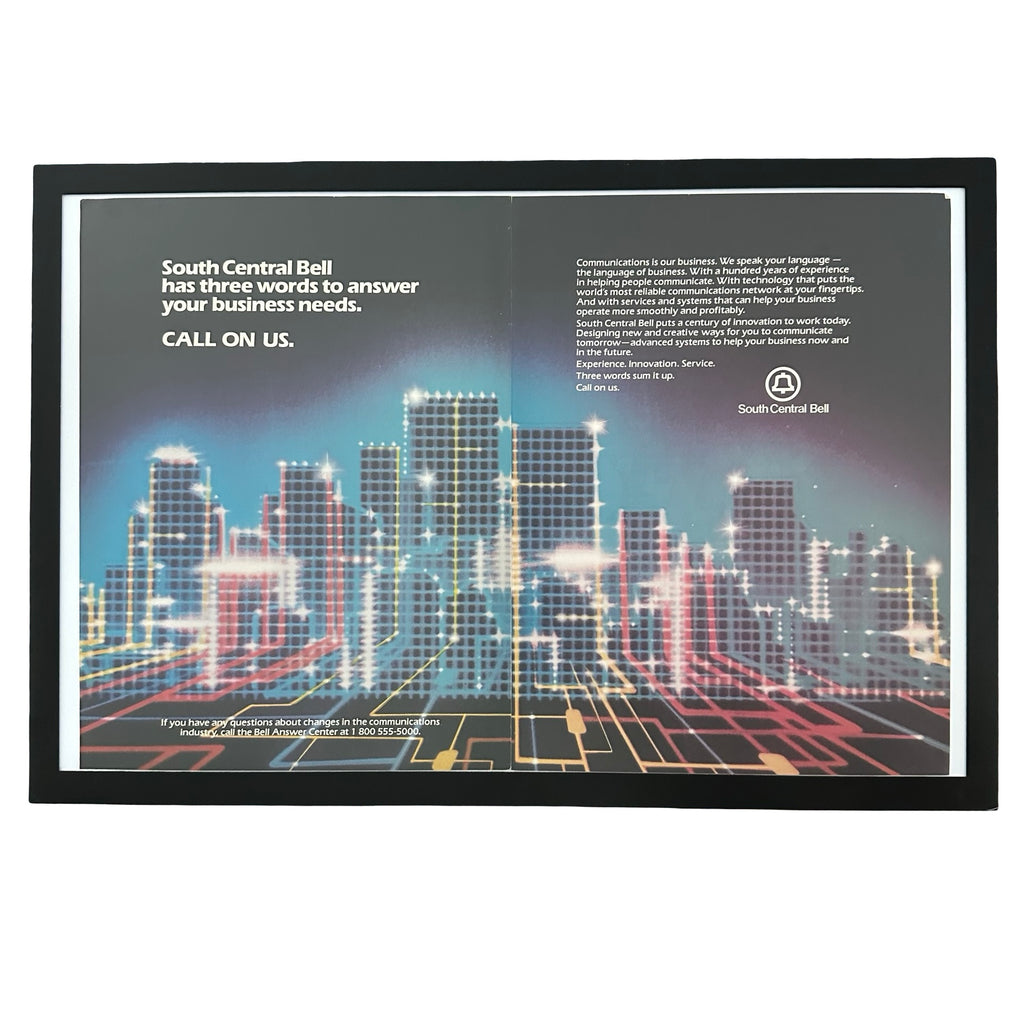 Framed vintage South Central Bell double page magazine ad with neon cityscape on white background