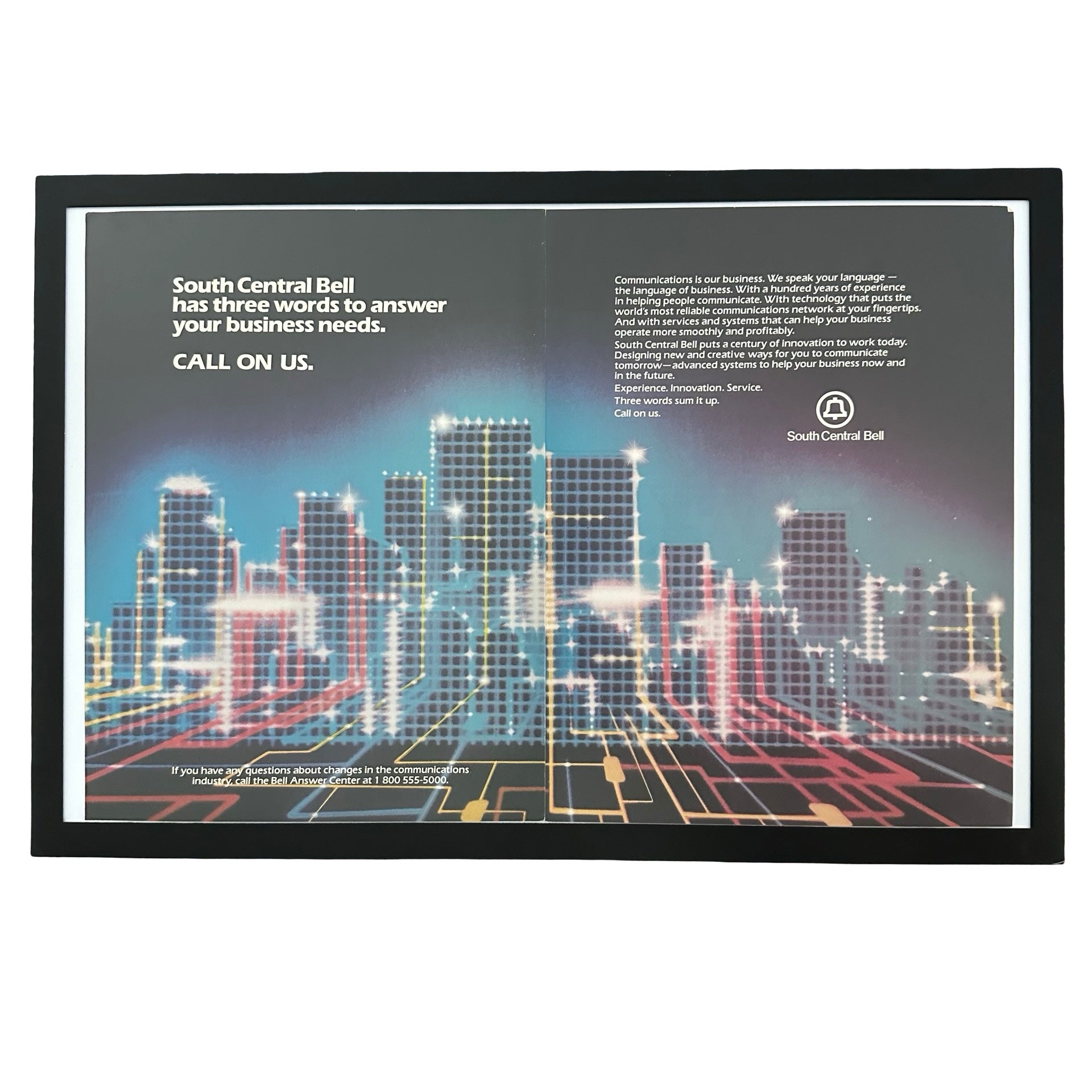 Framed vintage South Central Bell double page magazine ad with neon cityscape on white background