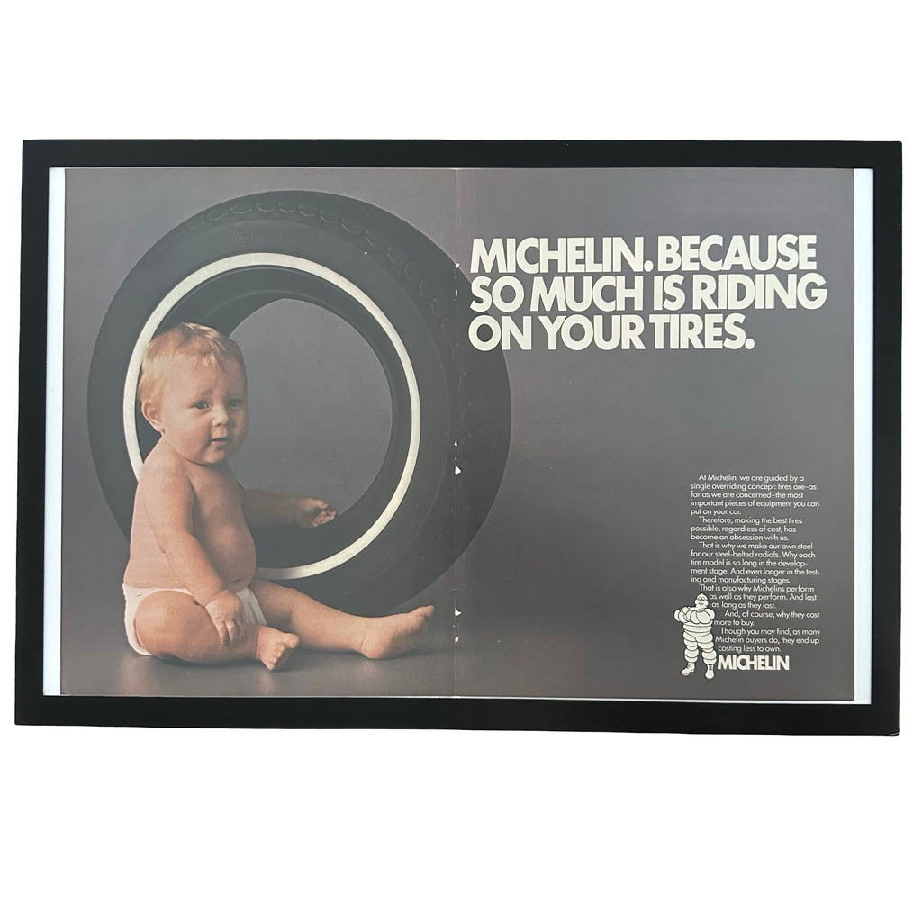 Framed vintage Michelin baby in tire double page magazine ad on white background
