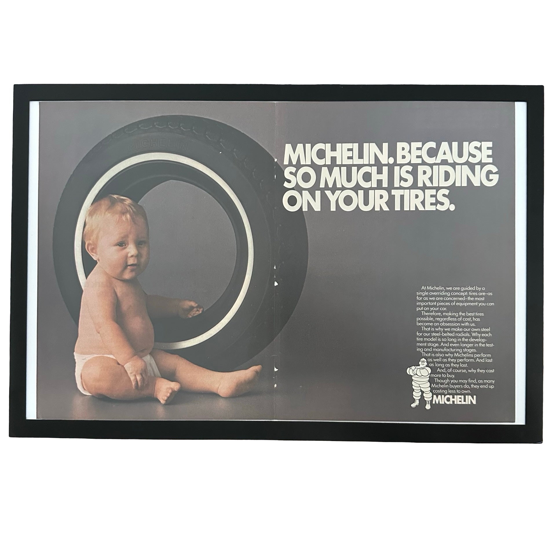 Framed vintage Michelin baby in tire double page magazine ad on white background