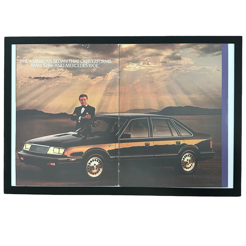Framed vintage Chrysler LeBaron double page magazine ad with Ricardo Montalban on white background