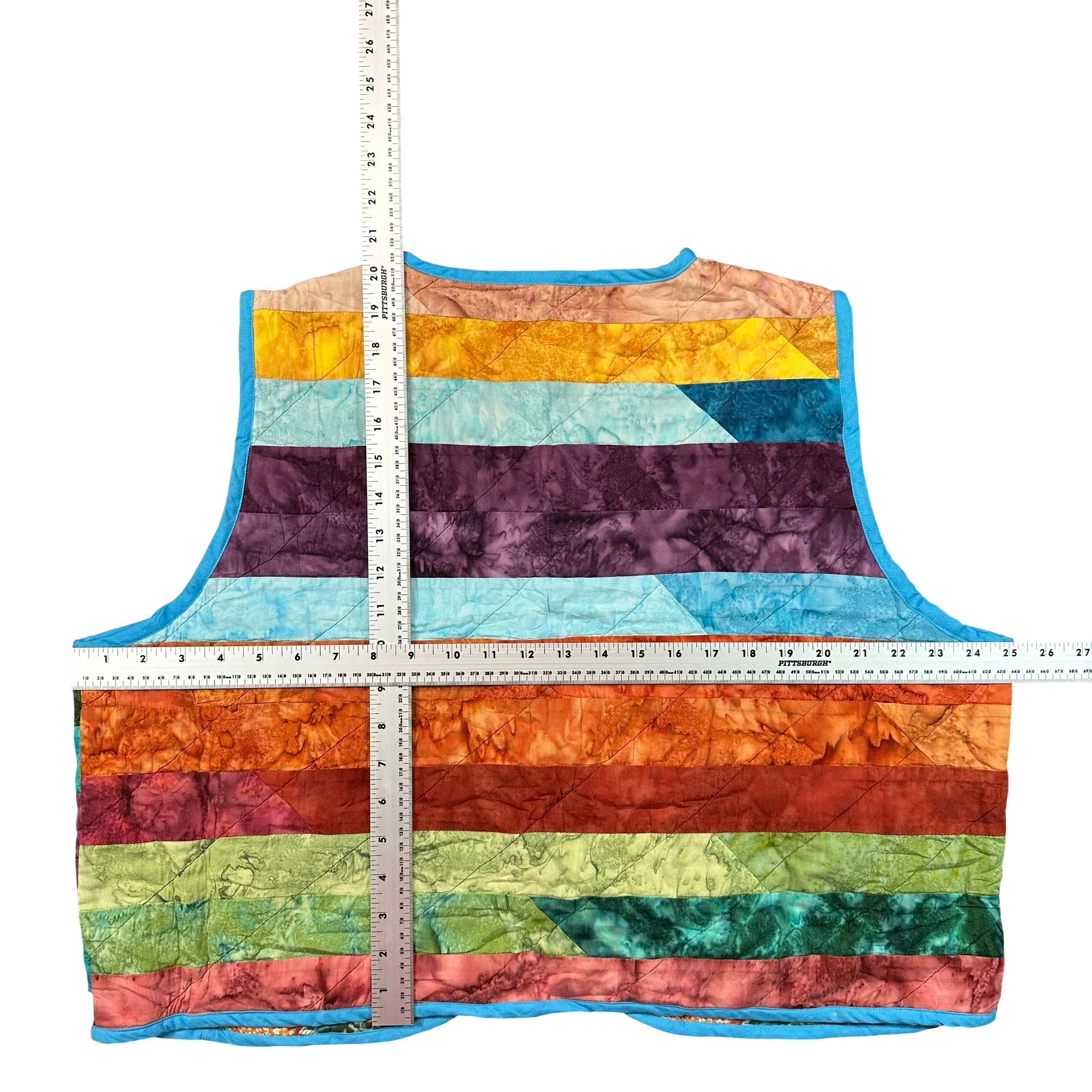 Rainbow Batik Stripe quilted vest rework, flat lay measurements with tape measure