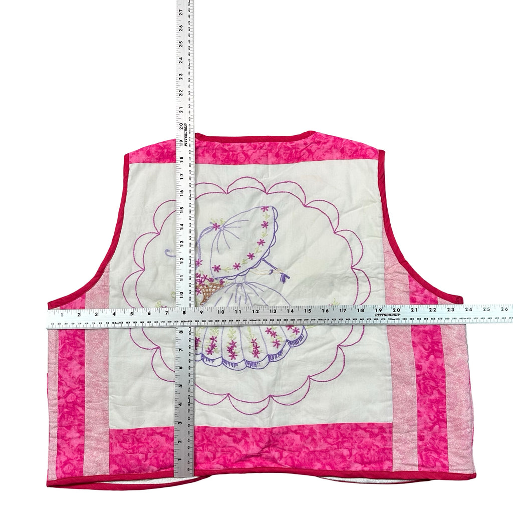 Pink Parasol Embroidery XL quilted vest rework, tape measure across the chest