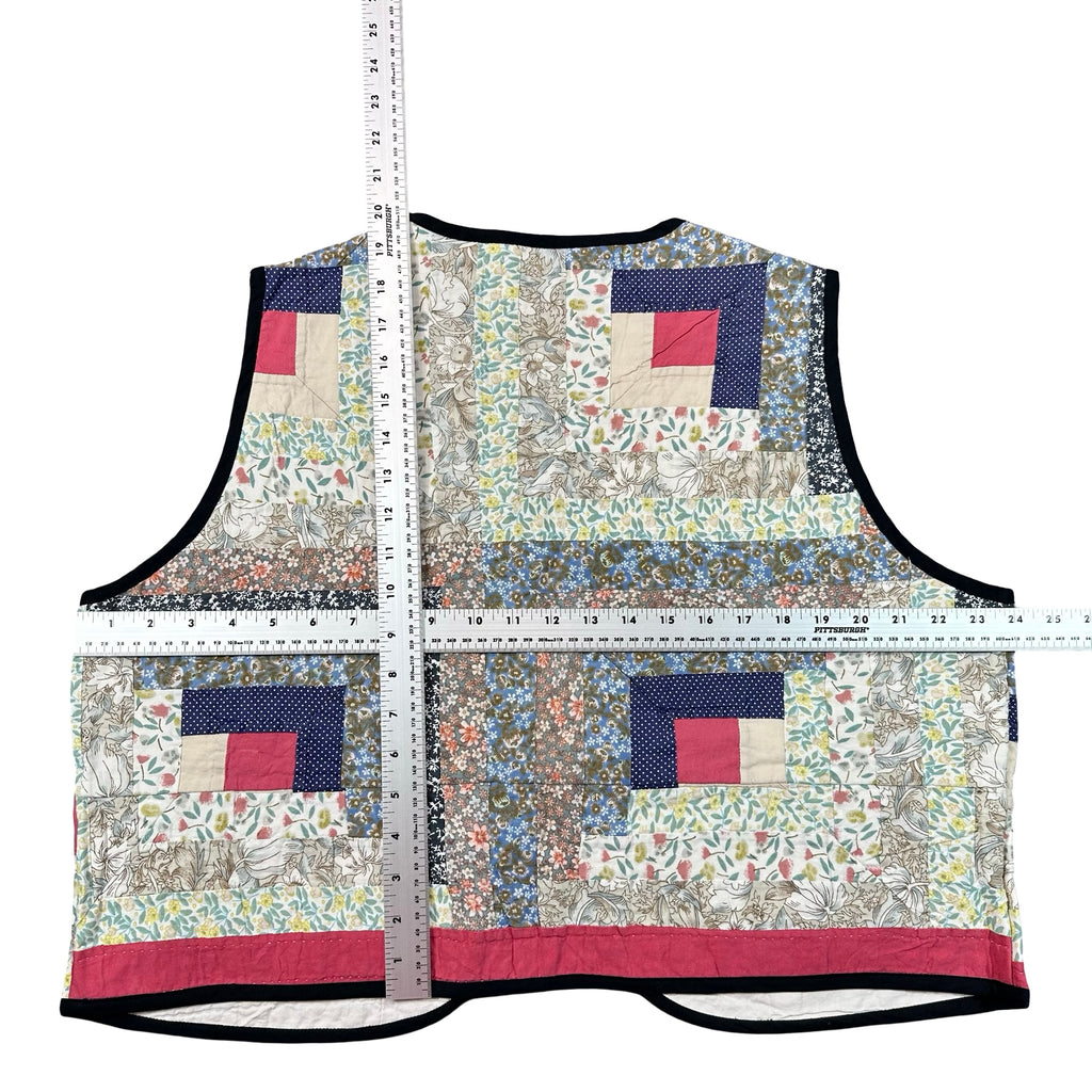 Wildflower Log Cabin XL quilted vest rework, tape measure across the chest