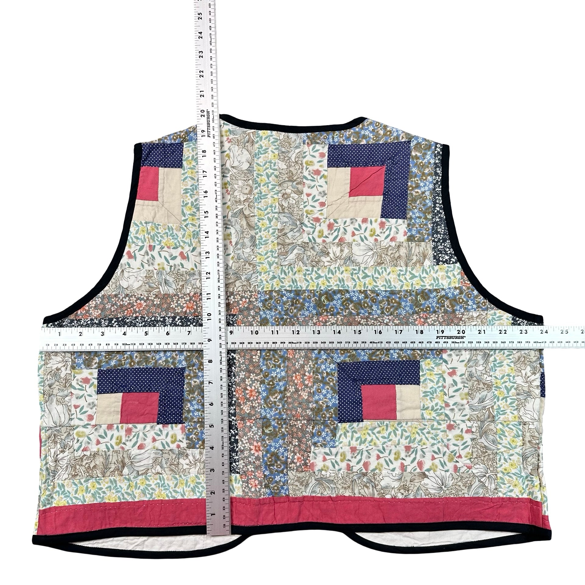 Wildflower Log Cabin XL quilted vest rework, tape measure across the chest