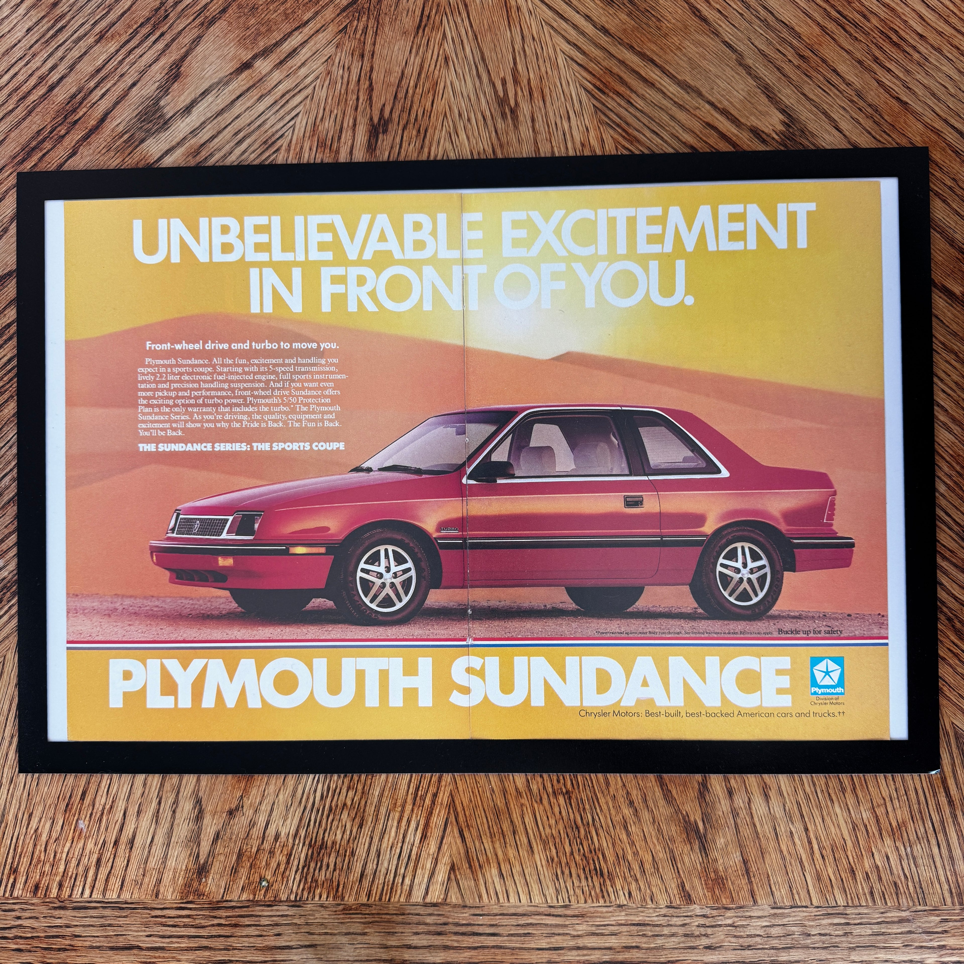 Framed vintage Plymouth Sundance Sports Coupe double page magazine ad