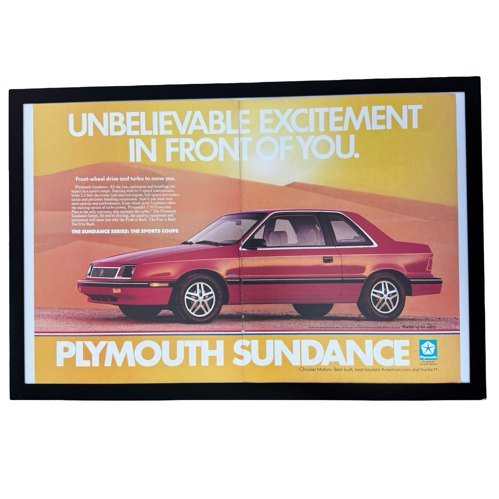 Framed vintage Plymouth Sundance Sports Coupe double page magazine ad on white background