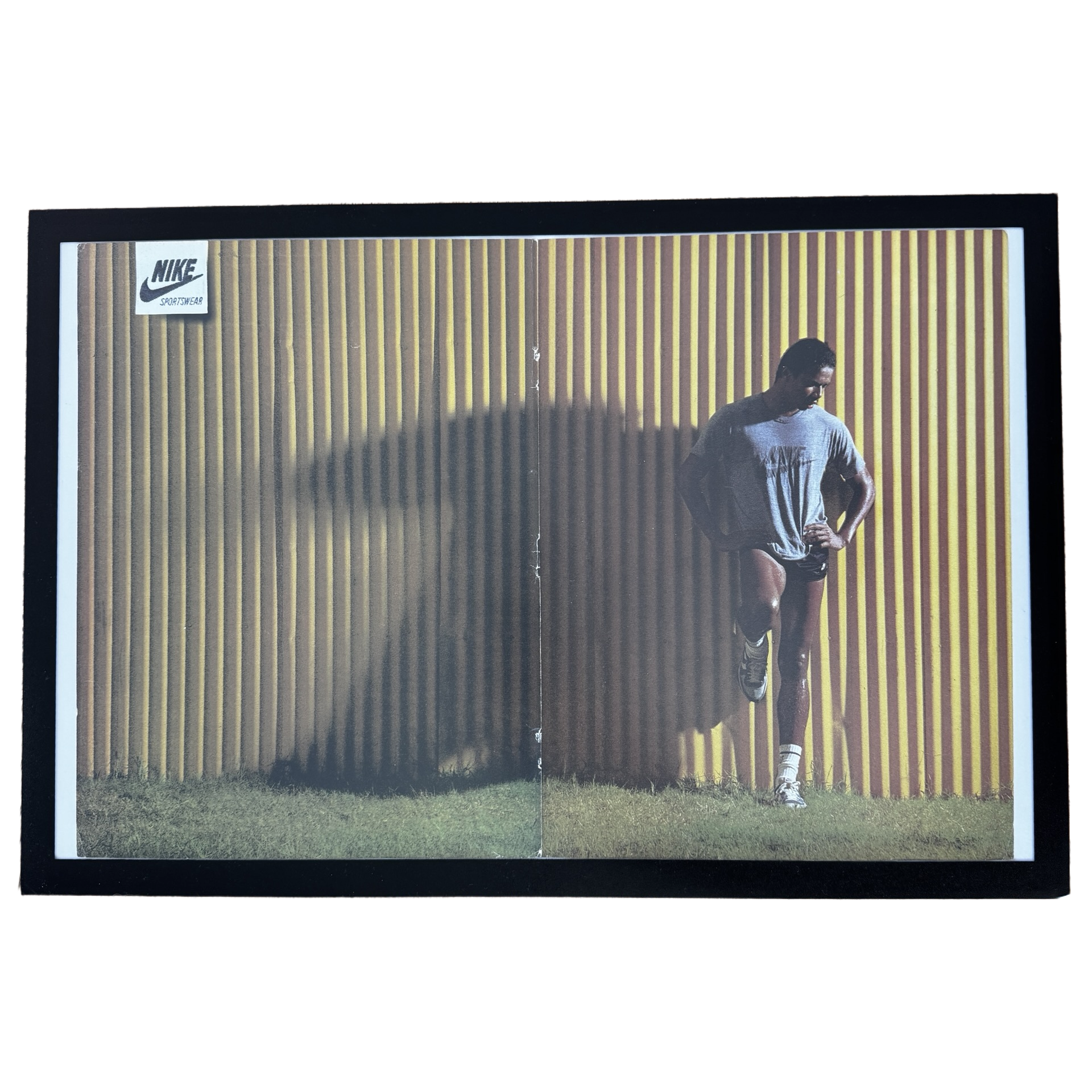 Framed vintage Nike Sportswear runner double page magazine ad on white background