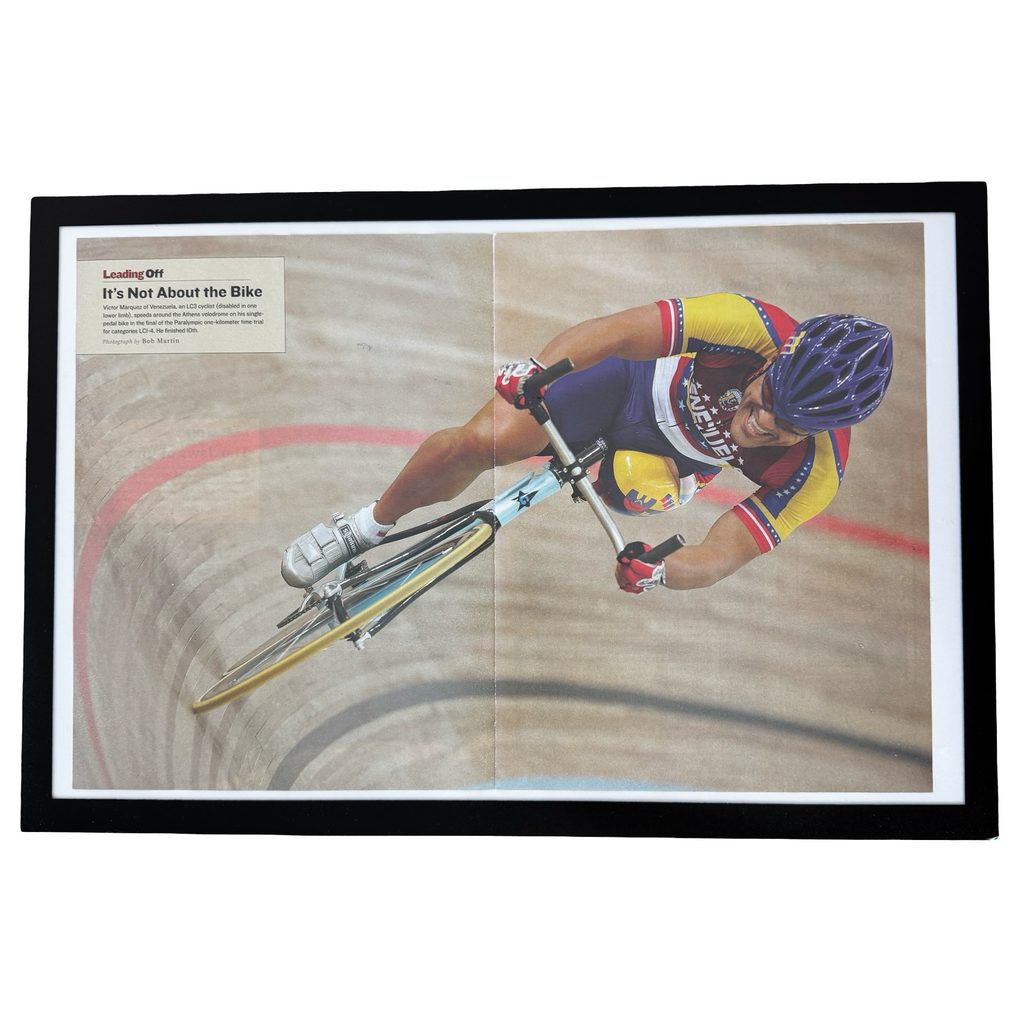 Framed vintage Paralympic track cycling Sports Illustrated double page magazine print on white background