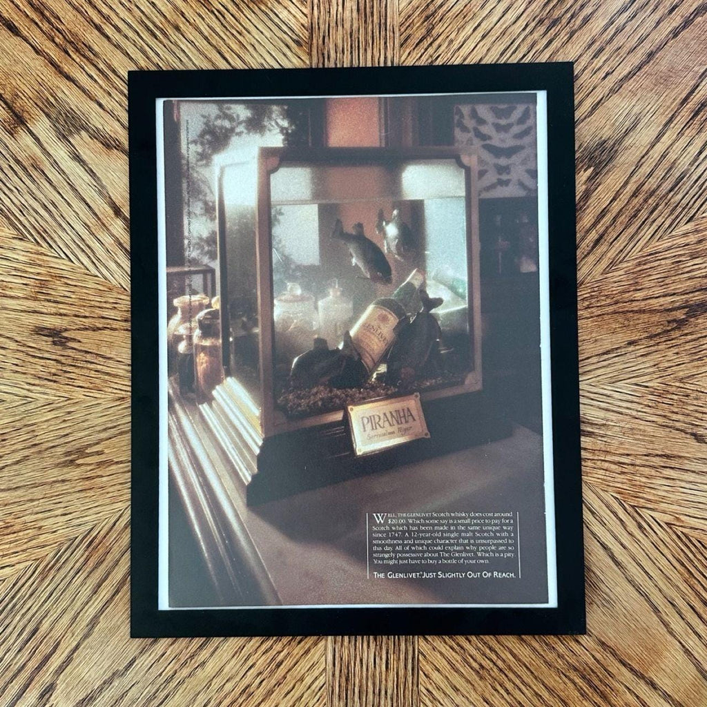1986 Vintage "The Glenlivet Just Slightly Out of Reach" Piranha Scotch Ad with Frame