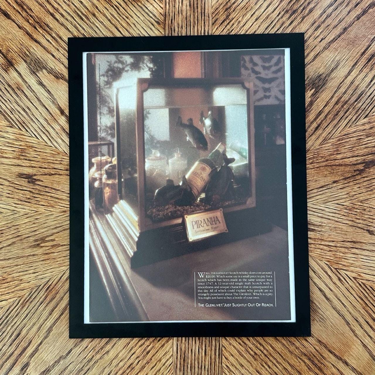 1986 Vintage "The Glenlivet Just Slightly Out of Reach" Piranha Scotch Ad with Frame